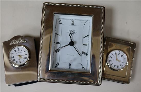 3 silver desk clocks and a blotter pad